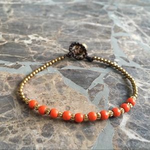 Hand woven beaded boho bracelet with brass bell